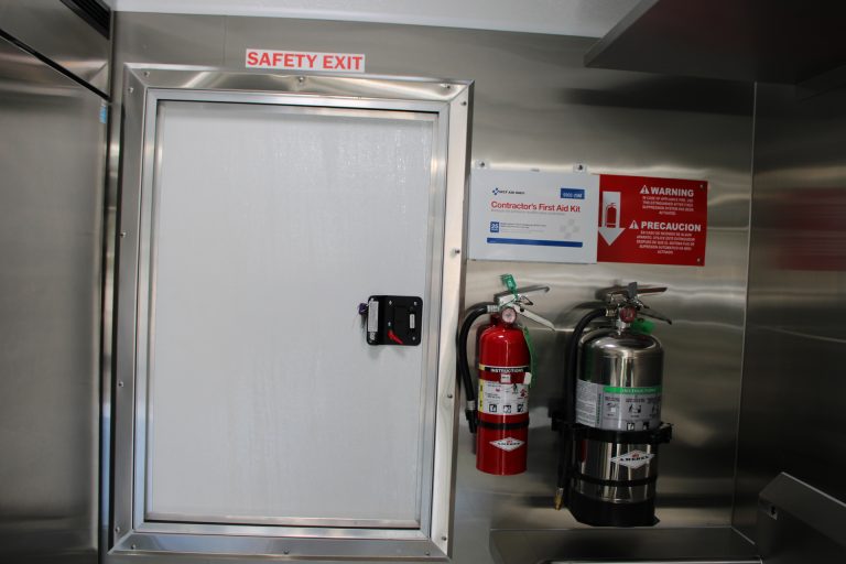 Safety exit and fire extinguishers inside Bobo’s Cafe coffee trailer