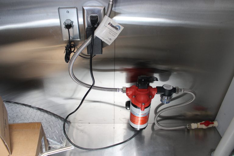 Plumbing utility equipment inside Bobo’s Cafe coffee trailer