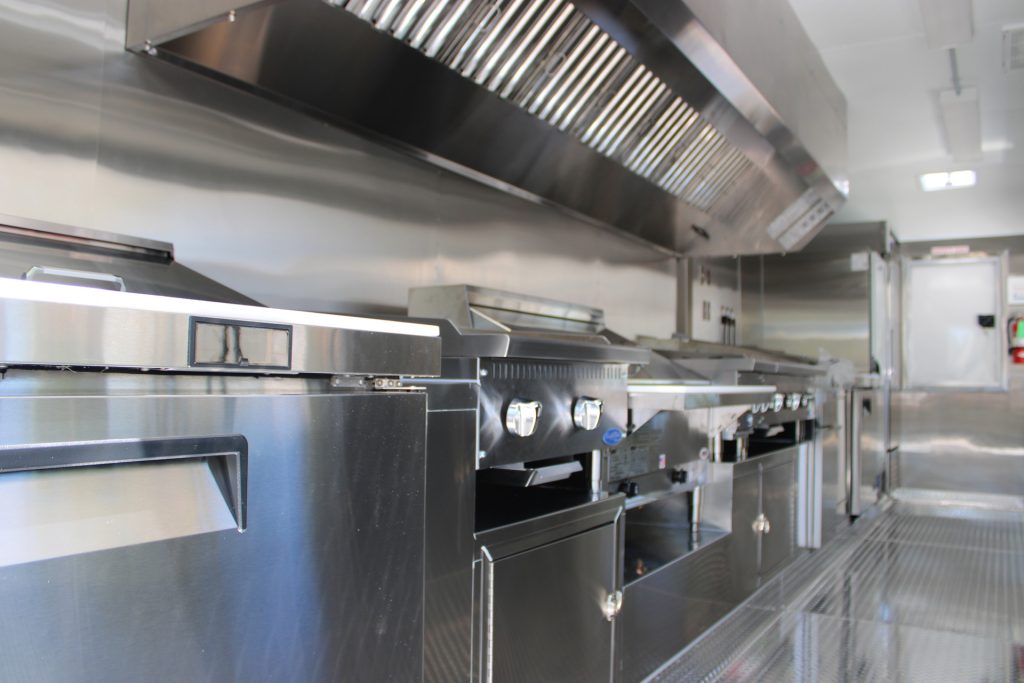 Commercial cooking line and ventilation hood inside The Salty Buccaneer