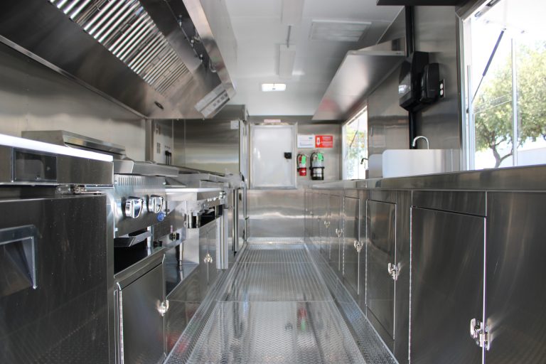 Interior of 22-ft school food trailer with stainless steel kitchen and central aisle