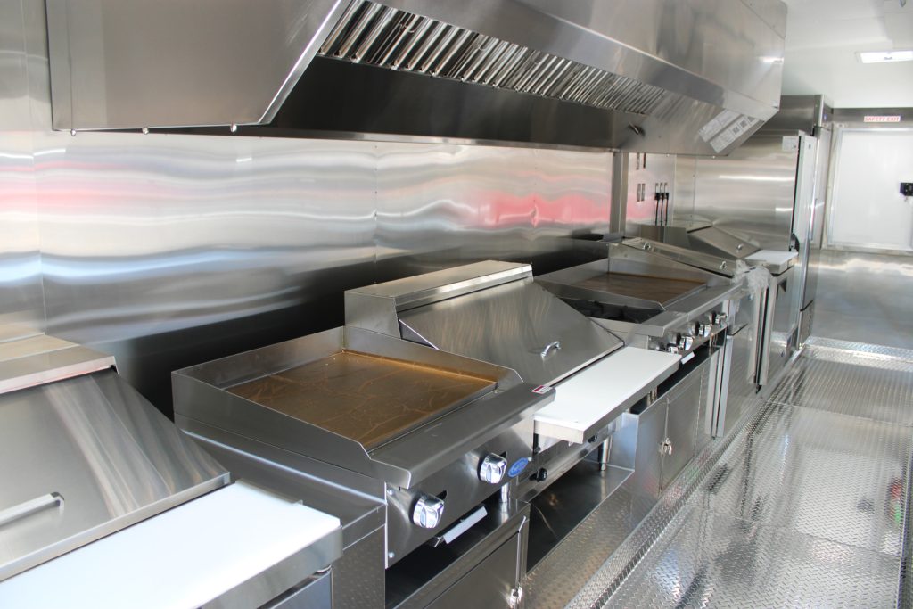 Stainless steel griddle equipment inside The Salty Buccaneer school food trailer