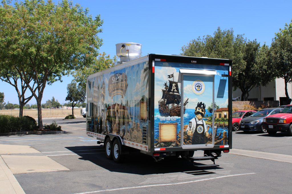 Rear exterior view of 22-ft school food trailer with custom Avenal branding