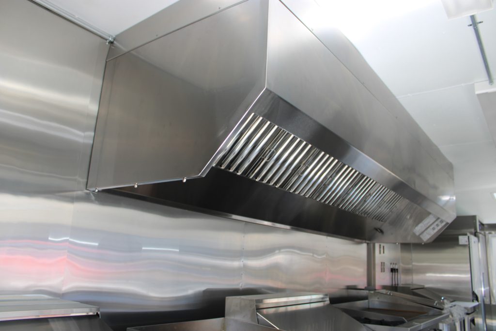 11-ft stainless steel ventilation hood above the commercial cooking line inside The Salty Buccaneer school food trailer