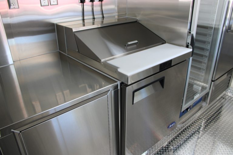 Commercial stainless steel preparation station inside school food trailer