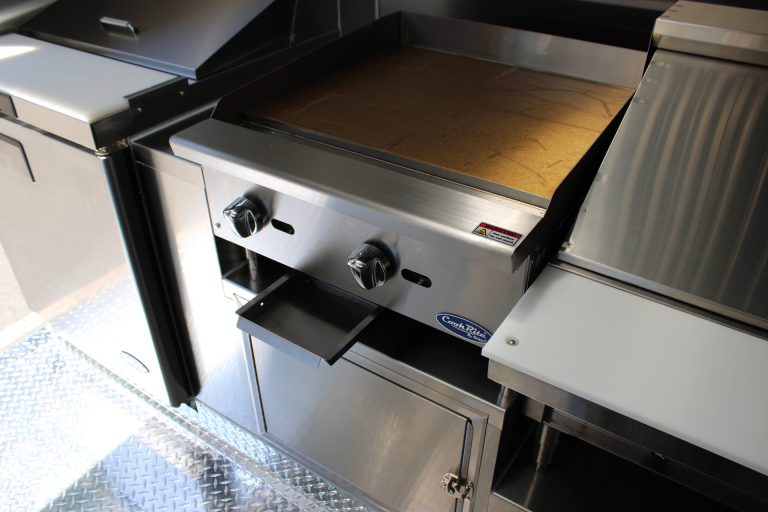Commercial griddle inside The Salty Buccaneer 22-ft school food trailer