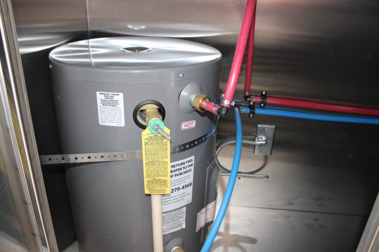 Commercial plumbing lines and shutoff valve inside 22-ft school food trailer