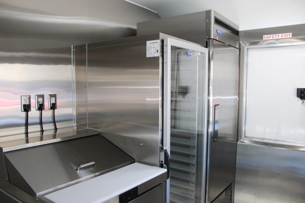 Insulated warming and holding cabinet inside The Salty Buccaneer 22-ft school food trailer