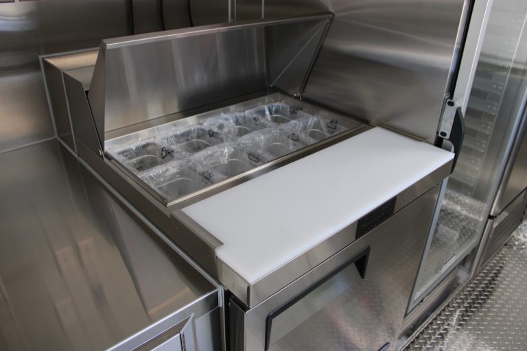 Stainless steel food-service workstation inside The Salty Buccaneer school food trailer
