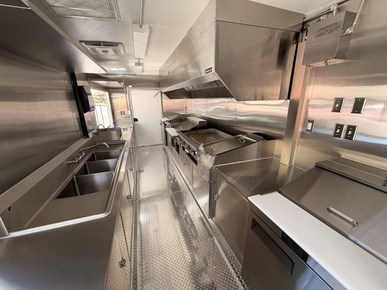 Commercial kitchen aisle inside The Salty Buccaneer 22-ft school food trailer
