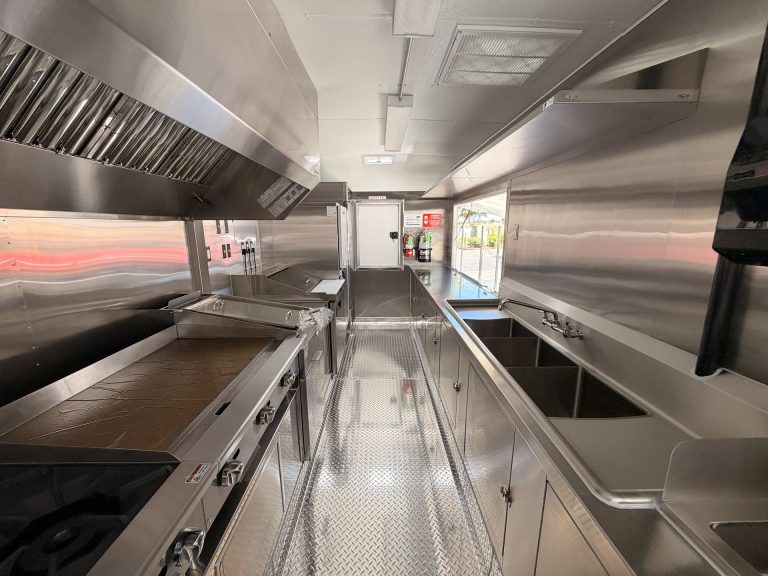 The Salty Buccaneer school food trailer interior with stainless steel kitchen and work aisle