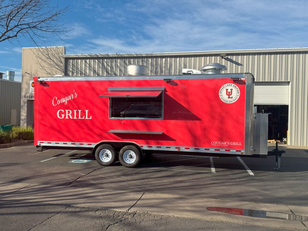 Cougar’s Grill school food trailer service side with concession window and Upper Lake branding