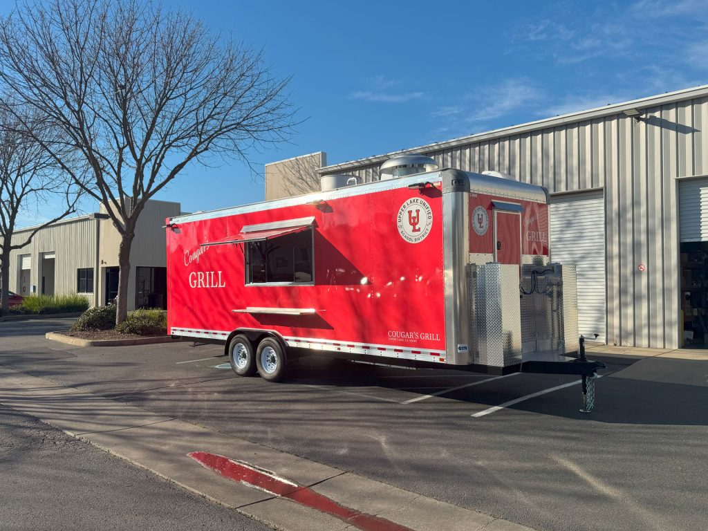 Front three-quarter view of Cougar’s Grill 24-ft school food trailer