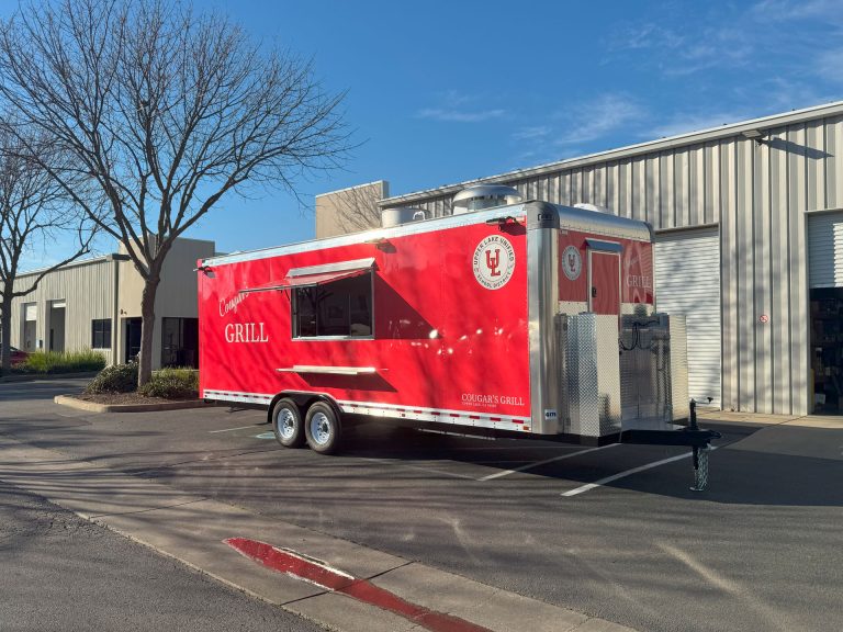 Front three-quarter view of Cougar’s Grill 24-ft school food trailer
