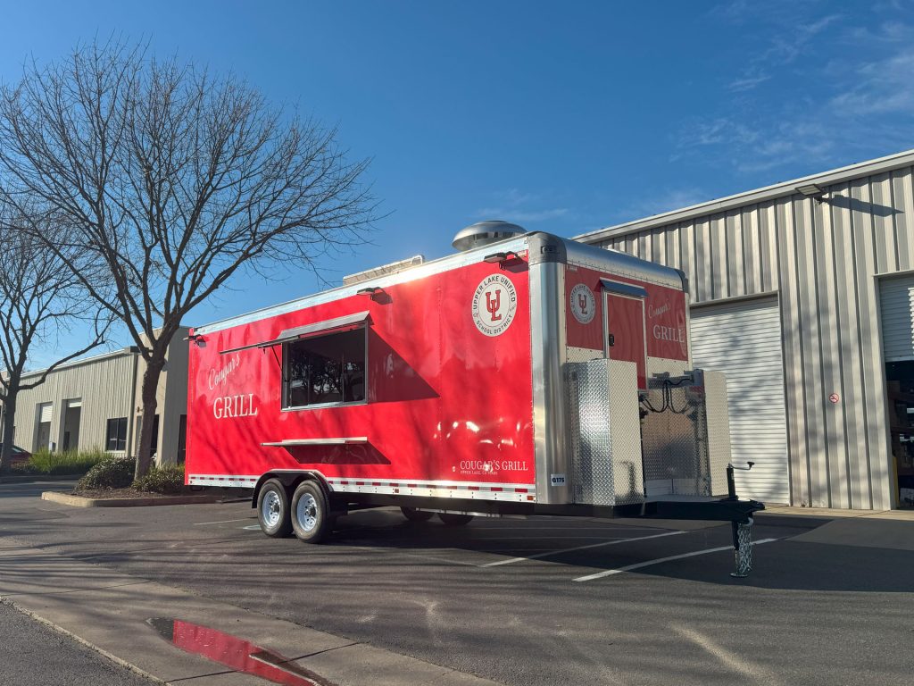 Cougar’s Grill 24-ft school food trailer with red school branding and service-side concession window