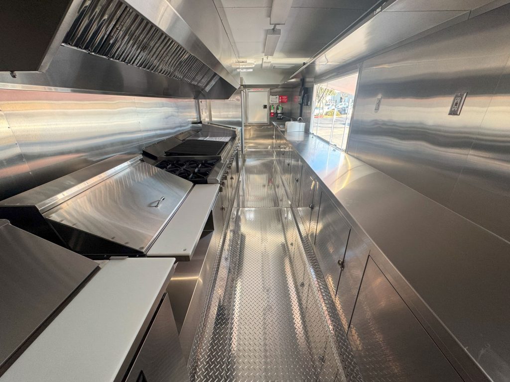 Commercial cooking equipment and ventilation inside Cougar’s Grill school food trailer