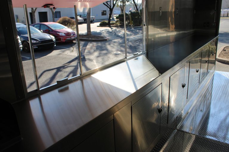 Stainless steel service counter inside Cougar’s Grill school food trailer