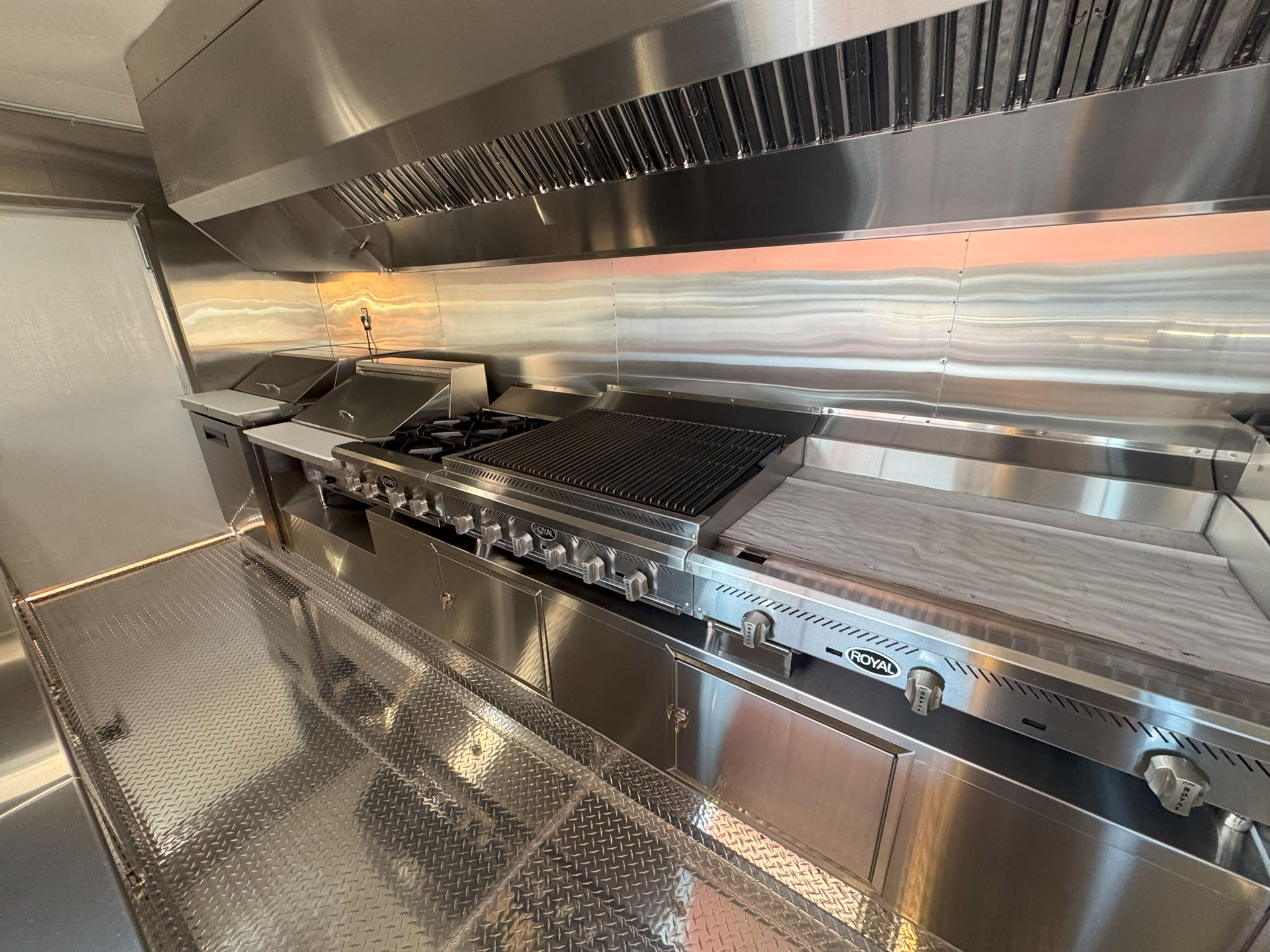 Stainless steel cooking and preparation area inside Cougar’s Grill 24-ft school food trailer