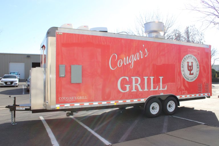 Full exterior profile of the Cougar’s Grill custom school food trailer.