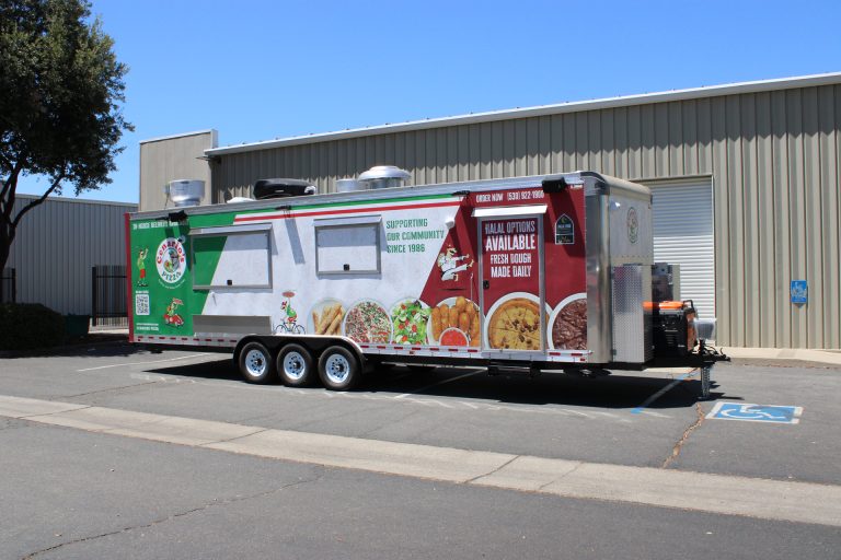 commercial pizza food trailer exterior with custom wrap, service windows, rooftop equipment, and triple-axle chassis