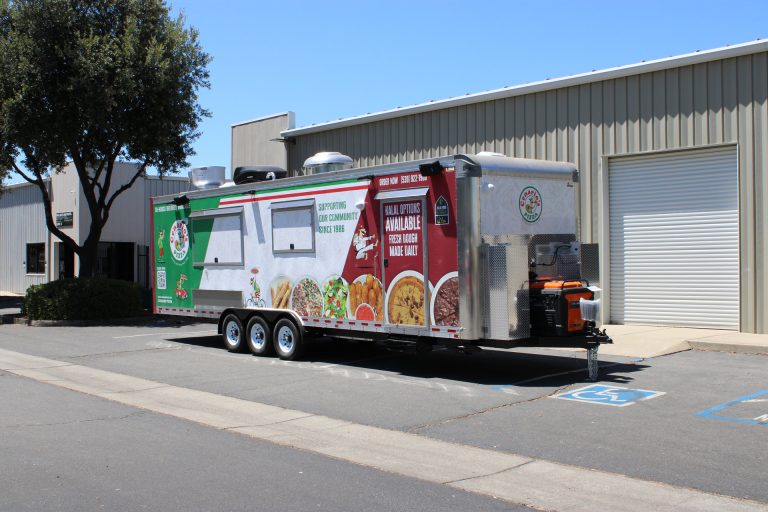 custom pizza food trailer with concession windows, exterior shelf, branded wrap, and commercial mobile kitchen body