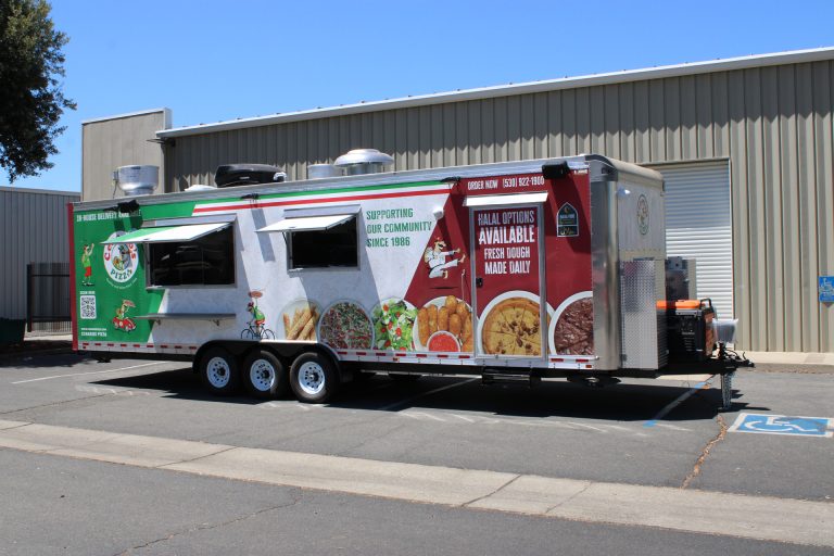 commercial pizza trailer exterior with custom food wrap, service windows, rooftop kitchen equipment, and triple axles