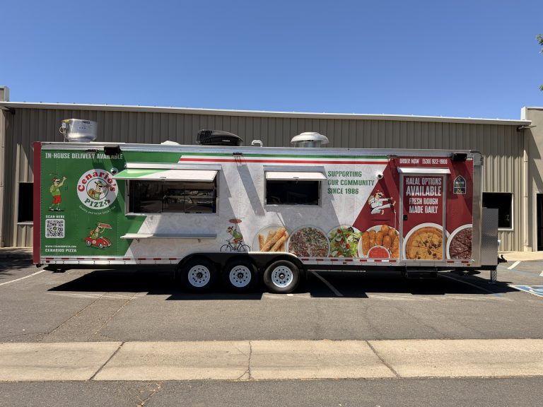 pizza kitchen trailer side profile with branded wrap, service windows, rooftop equipment, and triple-axle configuration