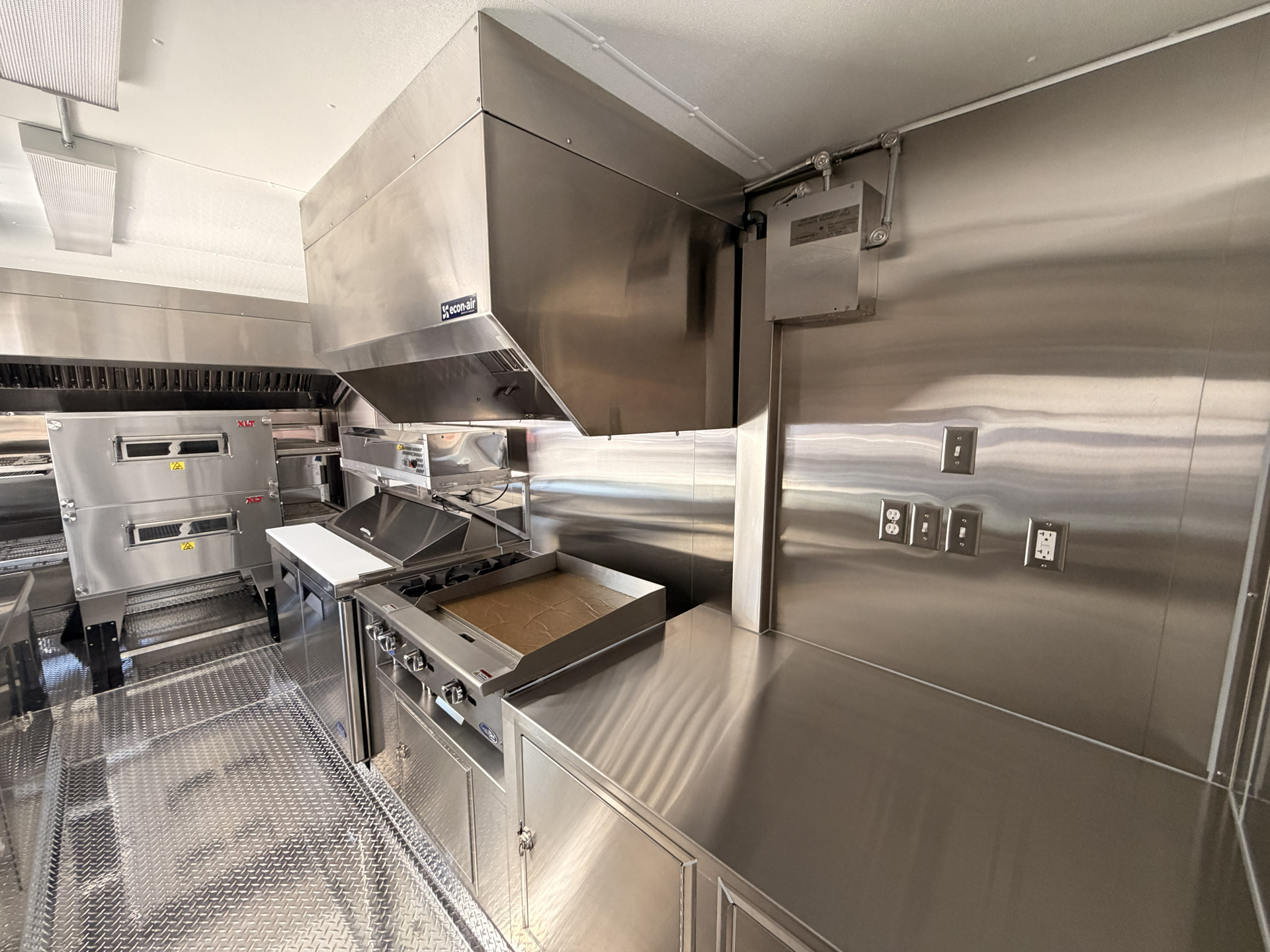 Food trailer cooking equipment with commercial ventilation hood