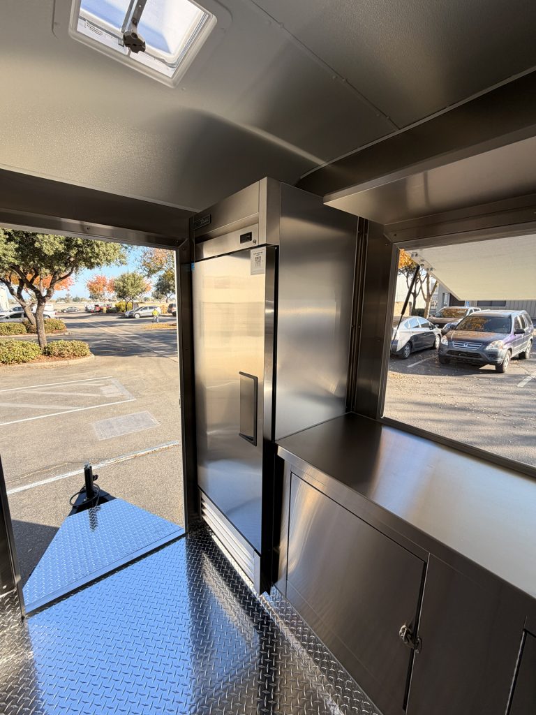 Commercial refrigerator and rear door inside 20ft training food trailer in Bonita CA