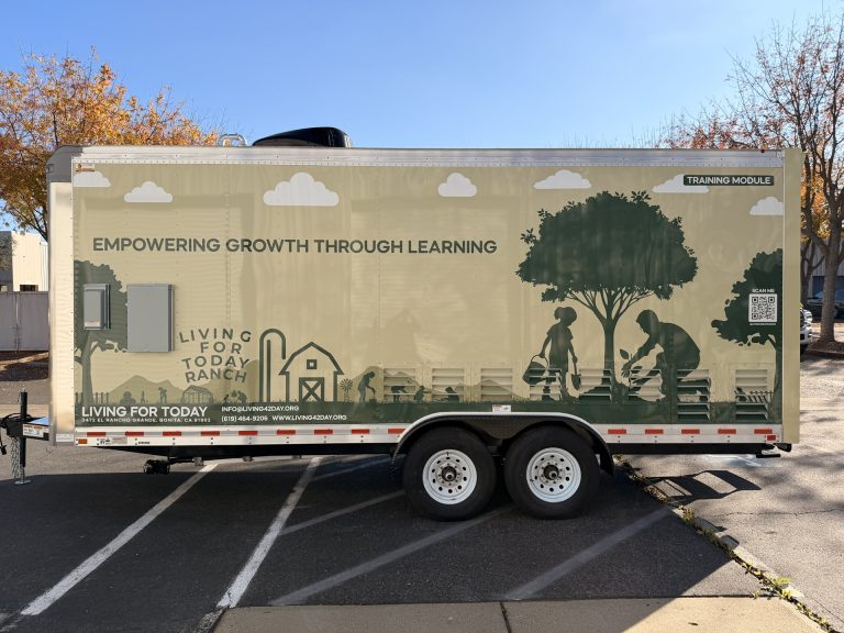 Full opposite side profile of 20ft training food trailer in Bonita CA with educational graphics