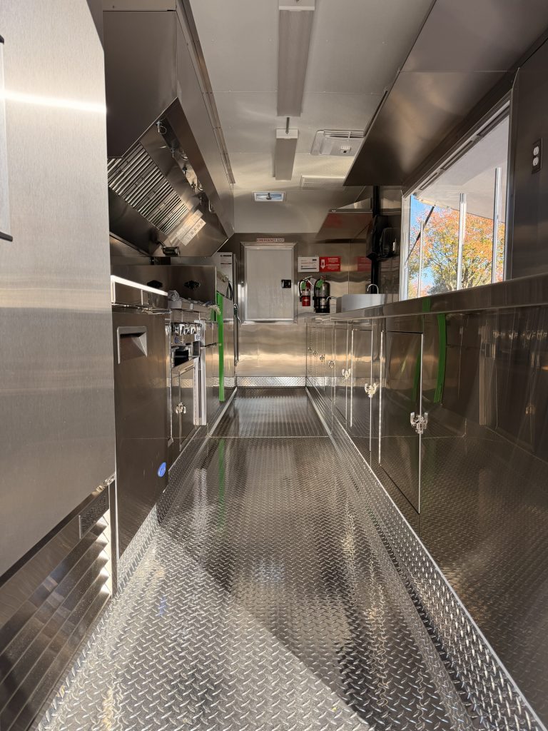 Stainless steel kitchen interior of BBQ food trailer in Gonzales CA with cooking line and prep area