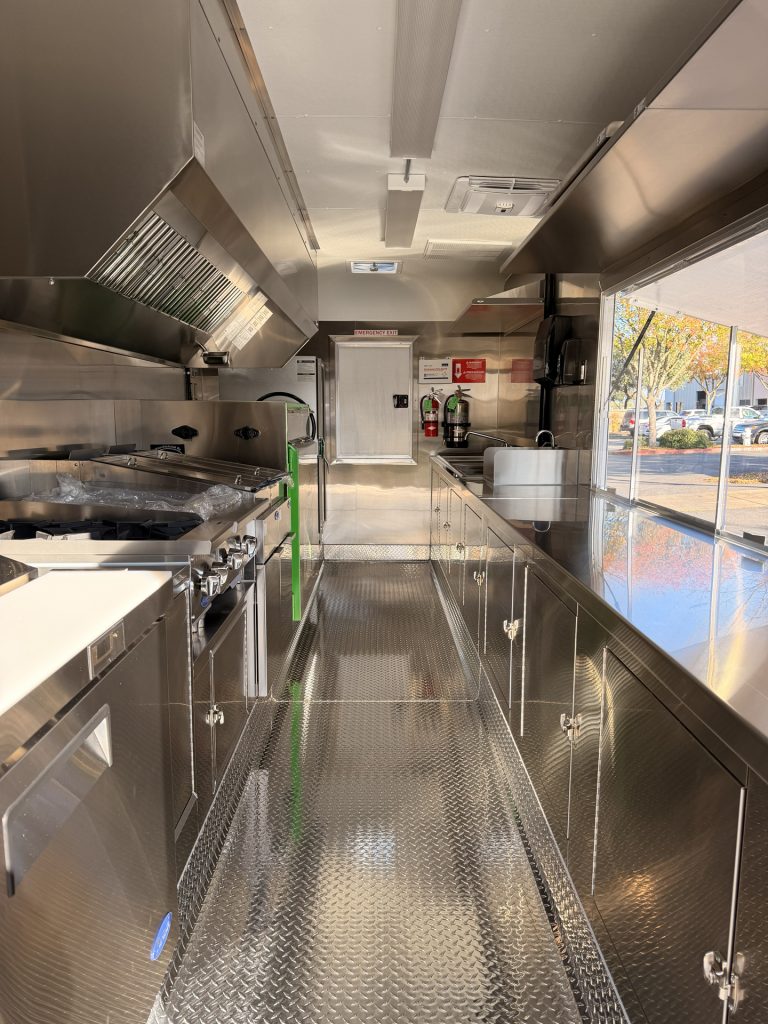 Commercial kitchen setup inside BBQ food trailer in Gonzales CA with stainless steel finish