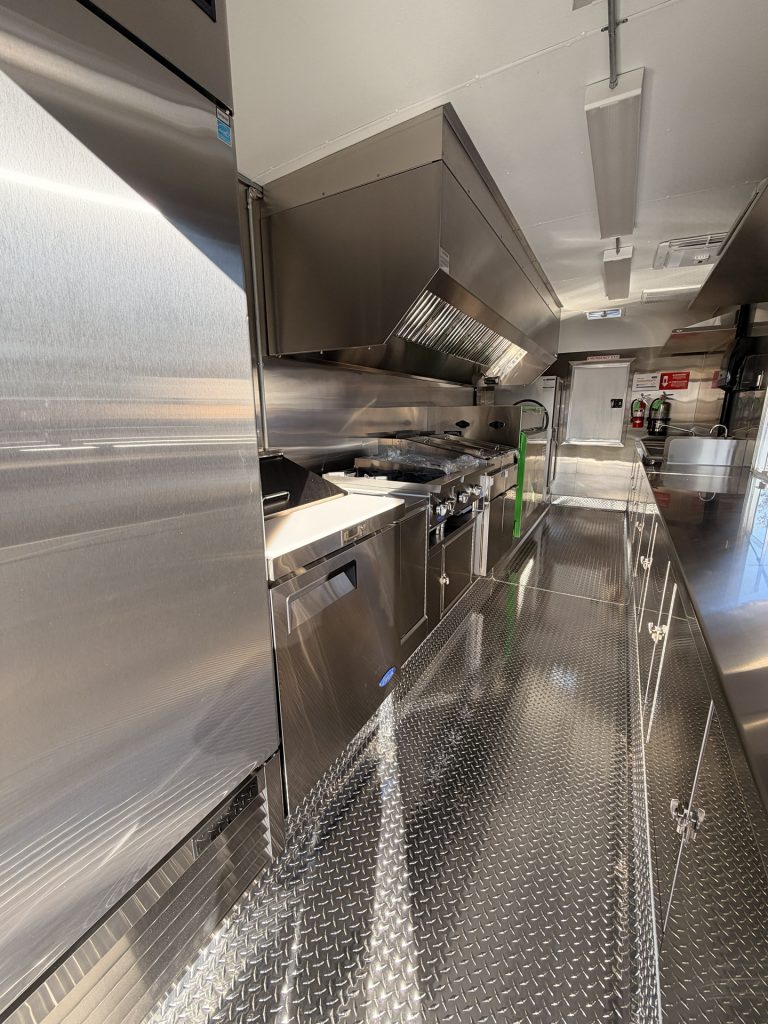 Cooking and prep layout inside BBQ food trailer in Gonzales CA with commercial hood system