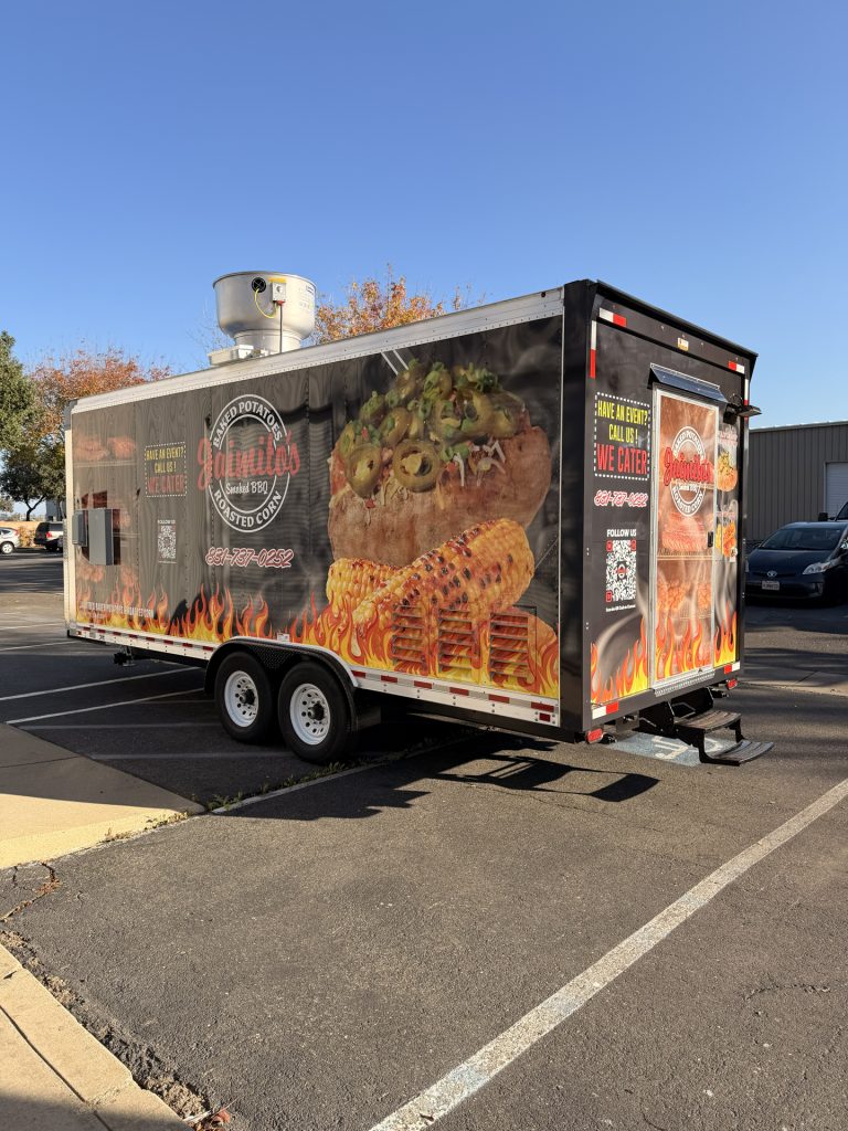 Rear side angle of BBQ food trailer in Gonzales CA with full height food graphics