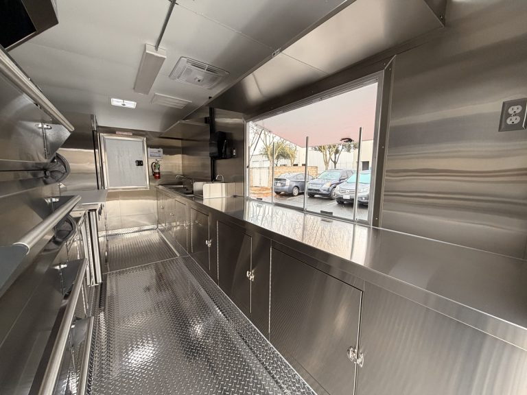 Stainless steel service counter and serving window inside pizza food trailer in Arroyo Grande CA