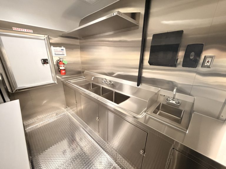 Three-compartment sink and handwash sink inside pizza food trailer
