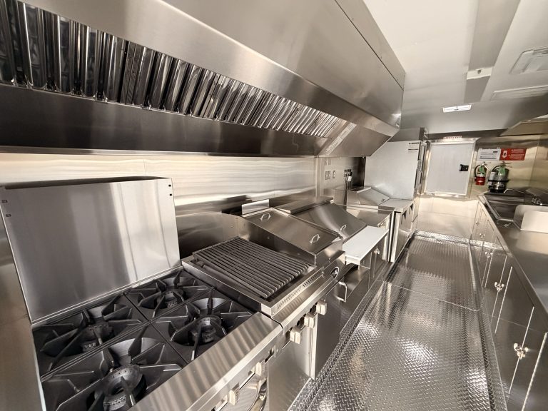 Commercial cooking equipment inside wine trailer in Walnut Creek CA with range and hood