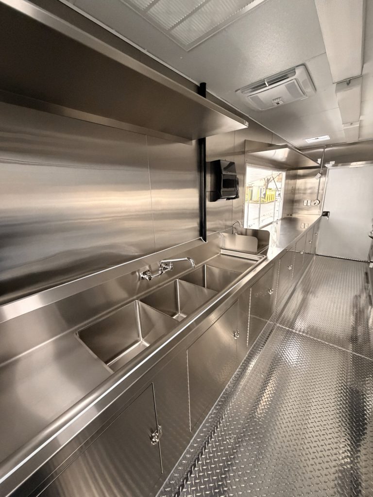 Three compartment sink inside wine trailer in Walnut Creek CA with stainless steel cabinets