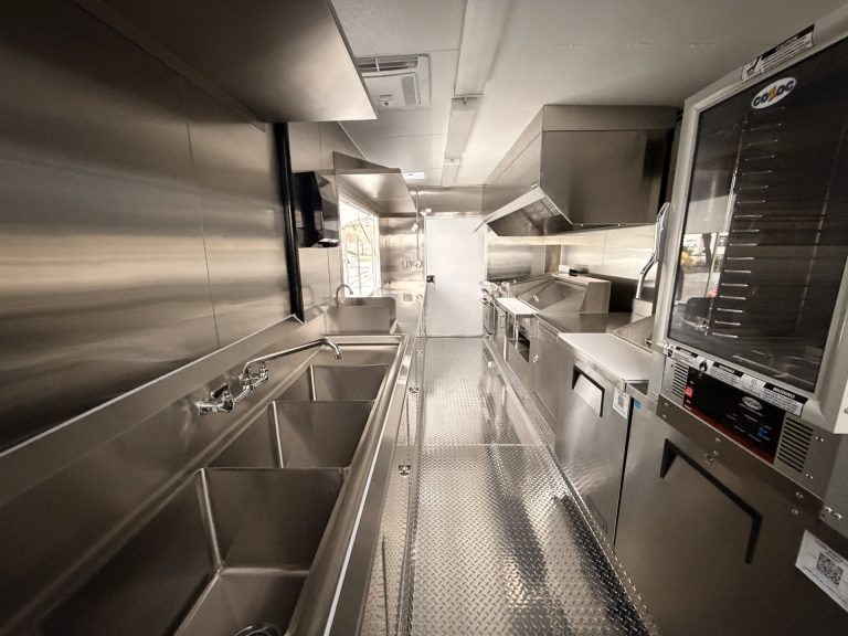 Full interior of wine trailer in Walnut Creek CA with sinks, refrigeration, and stainless steel finish
