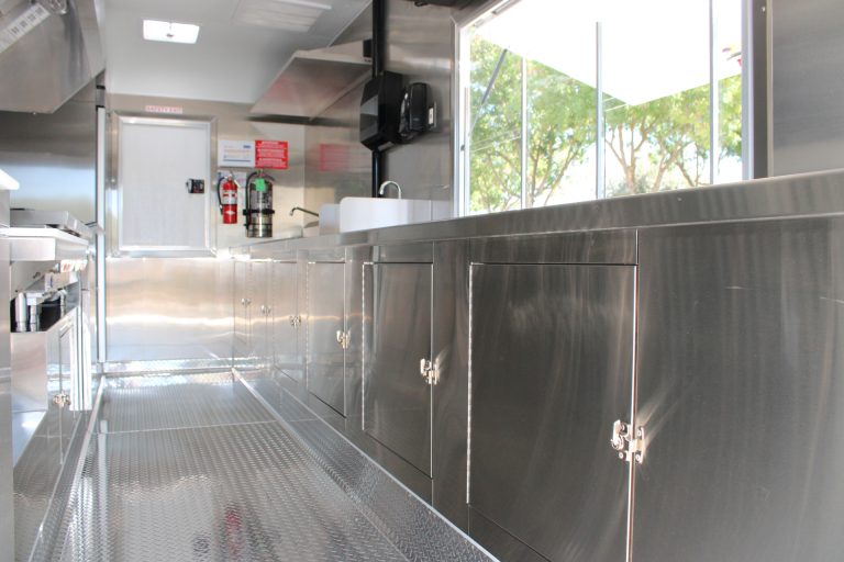 Stainless steel prep cabinets inside 16ft taco food trailer in Watsonville CA