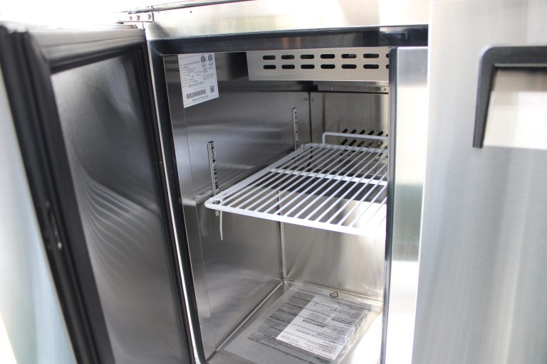 commercial refrigerator interior in food trailer with adjustable wire shelving