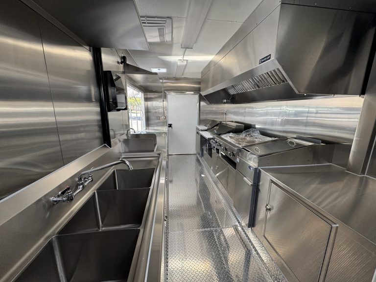 Interior kitchen of 16ft taco food trailer in Watsonville CA with cooking line and sink