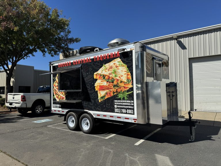 Front corner view of 16ft taco food trailer in Watsonville CA with Soccer Central Taqueria wrap