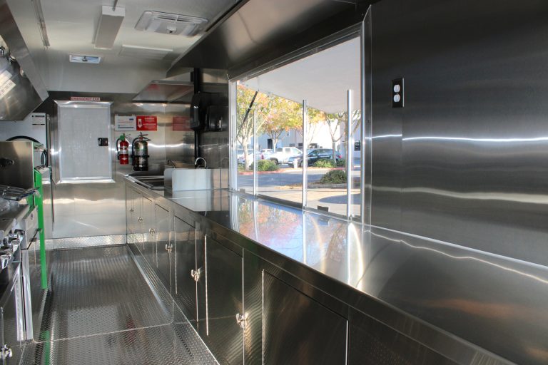Serving window view inside BBQ food trailer in Gonzales CA with stainless prep counter