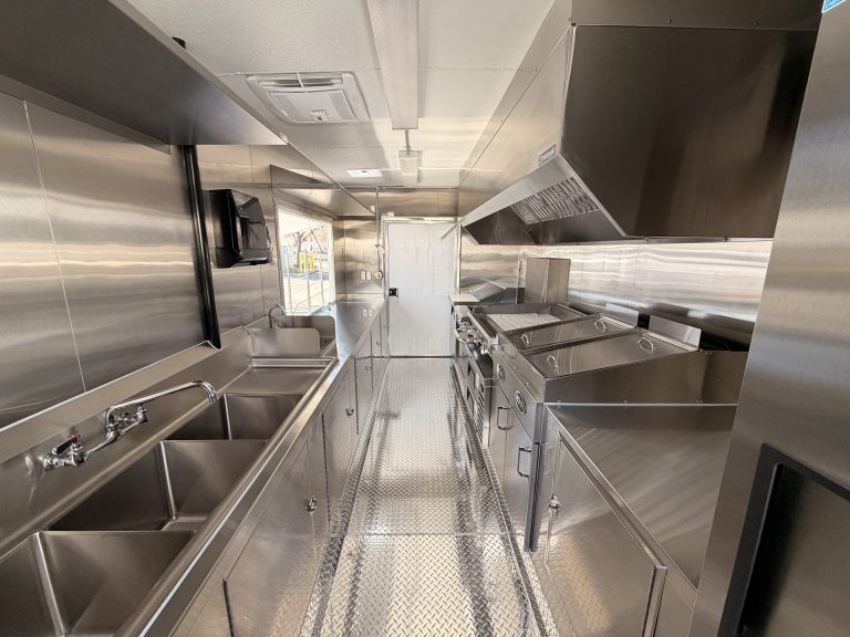 Limitless Kitchen food trailer full interior view with commercial sink, cooking line, exhaust hood, welded stainless steel cabinets and diamond plate flooring