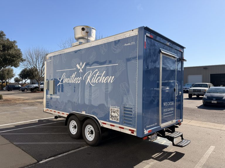 Limitless Kitchen 16ft food trailer rear wall view with brand logo, QR code, contact details and rooftop exhaust unit on blue 3M vinyl wrap