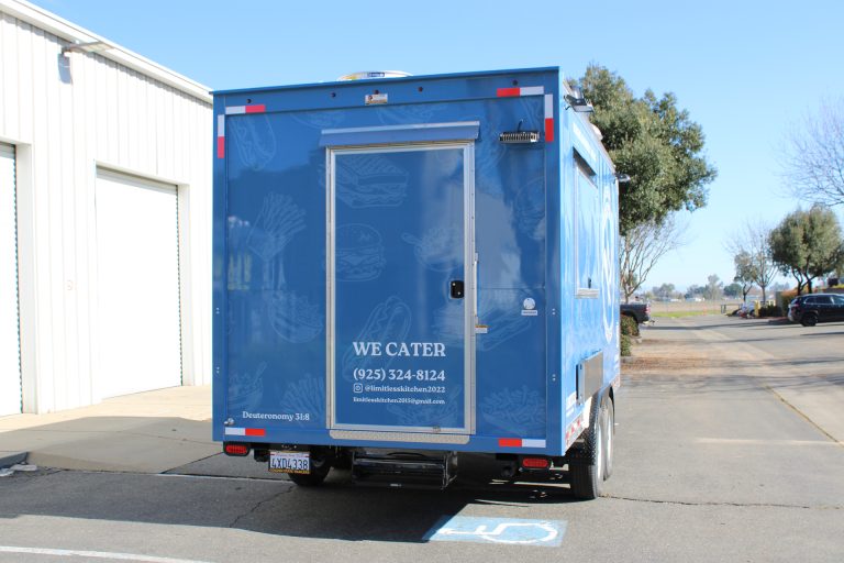 Limitless Kitchen 16ft food trailer rear door with we cater text, contact details and blue 3M vinyl wrap, custom build Golden State Trailers Martinez CA