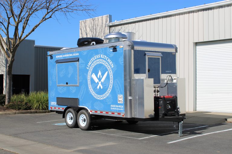 Limitless Kitchen 16ft food trailer front three-quarter view with blue 3M wrap, tongue jack, generator compartment and rooftop equipment, Martinez CA