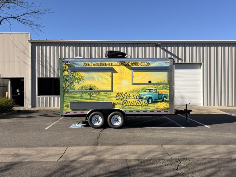 Sip'n on Sunshine 16ft lemonade trailer full side view with vintage truck lemon orchard 3M wrap, closed serving windows and tandem axles, Yuba City CA