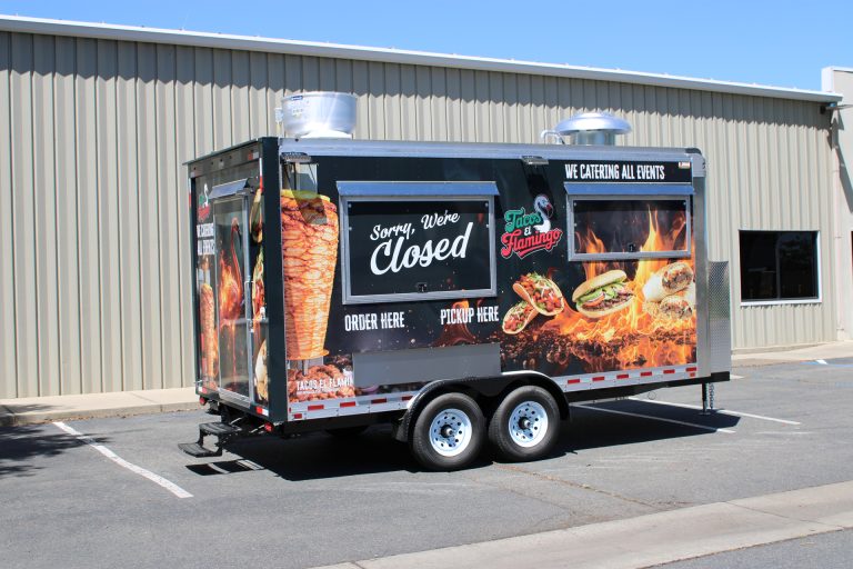Black 16ft Mexican food trailer with flame graphics and dual service windows for Tacos El Flamingo