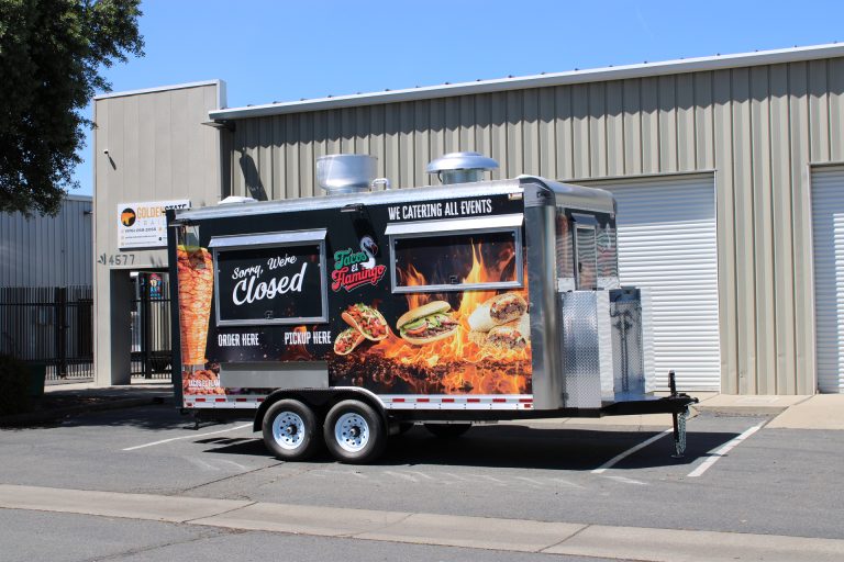 Custom 16ft Mexican catering food trailer with large flame wrap and dual serving windows in California